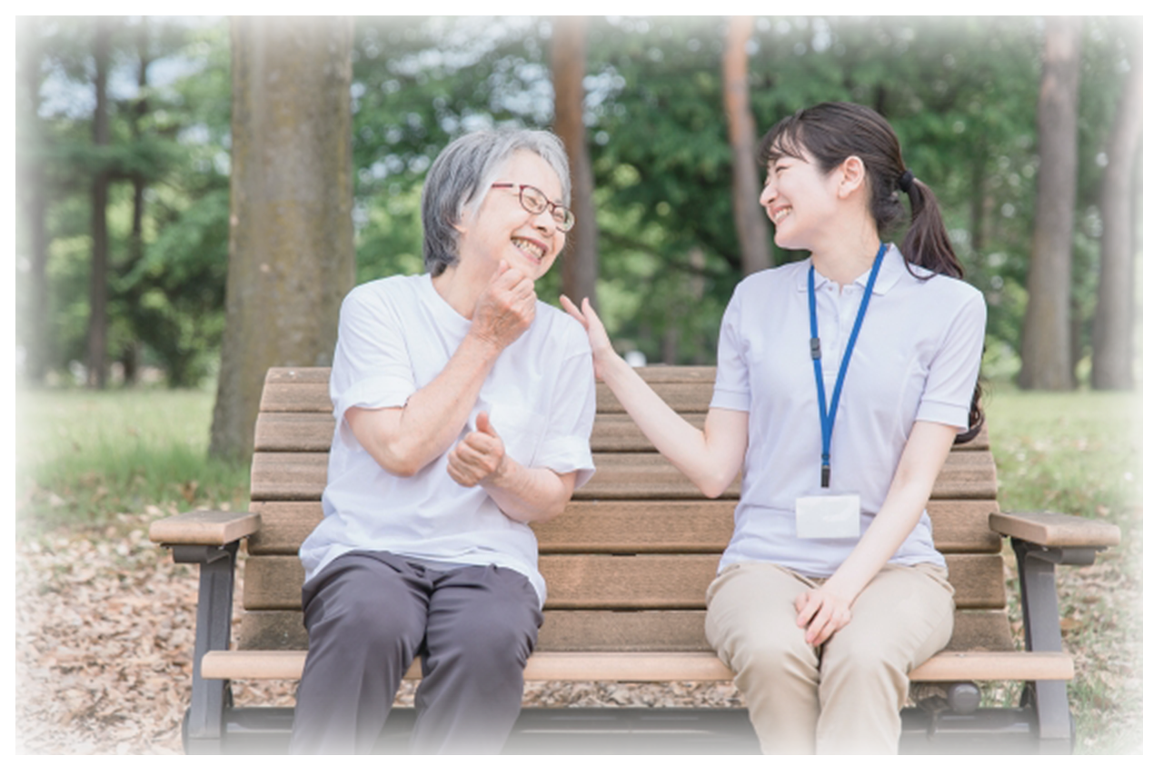 笑顔で話す女性スタッフと高齢女性